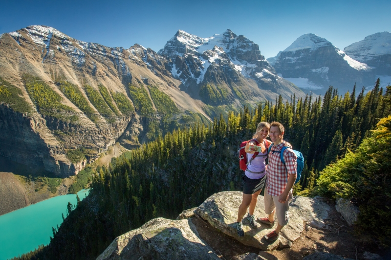 At Little Beehive on the Lake Agnes Tea House Trail in Banff National Park, a couple is taking a photo